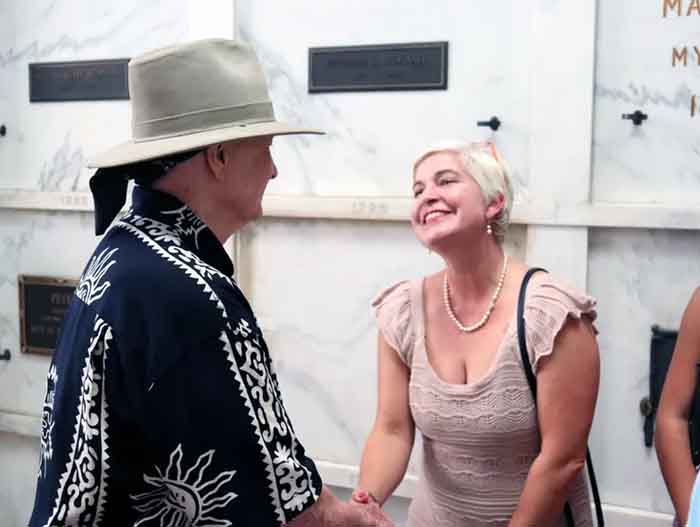 Christopher greets Diane Flores